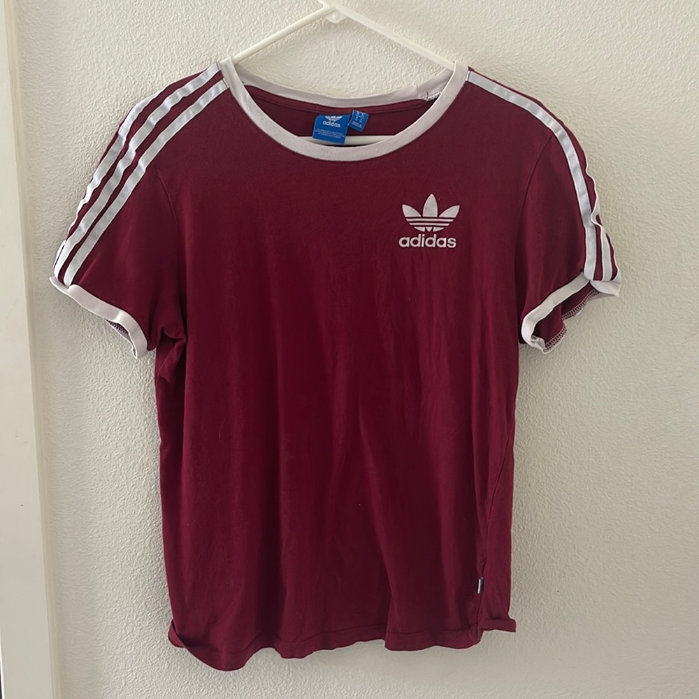 Burgundy adidas brand shirt with white stripes